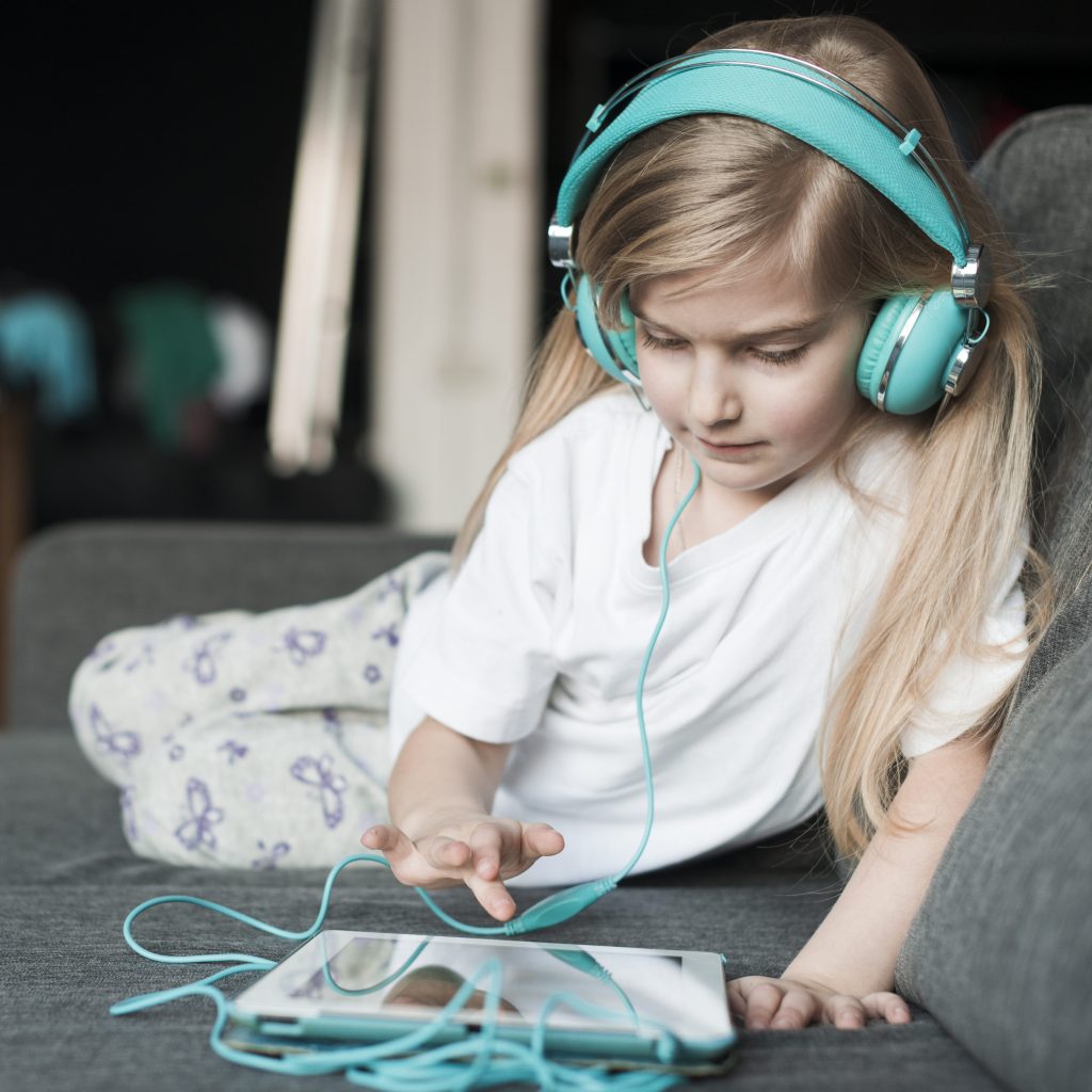 young girl with headphones tablet